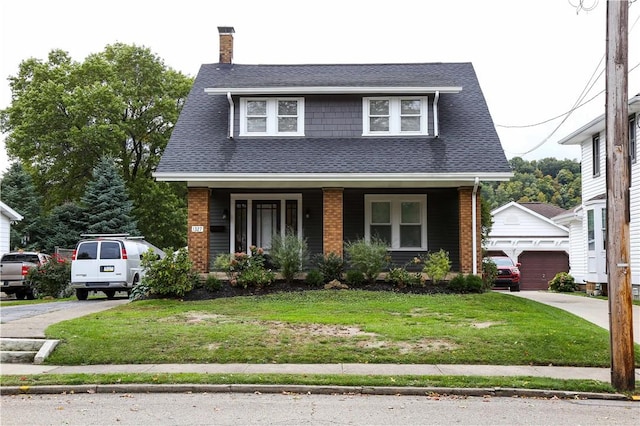 view of front facade with a garage, an outdoor structure, a front lawn, and a porch