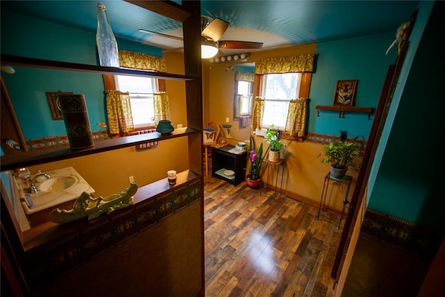 interior space featuring ceiling fan and sink