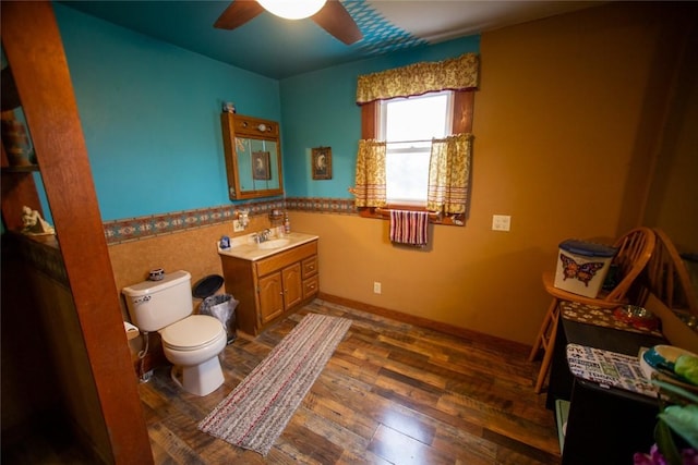 bathroom with ceiling fan, vanity, toilet, and hardwood / wood-style floors