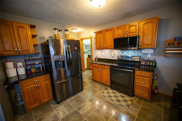 kitchen featuring stainless steel appliances, backsplash, and a textured ceiling