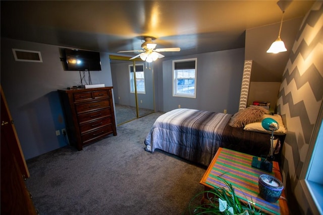 carpeted bedroom with ceiling fan and a closet