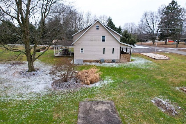 view of property exterior with a carport, a yard, and central air condition unit