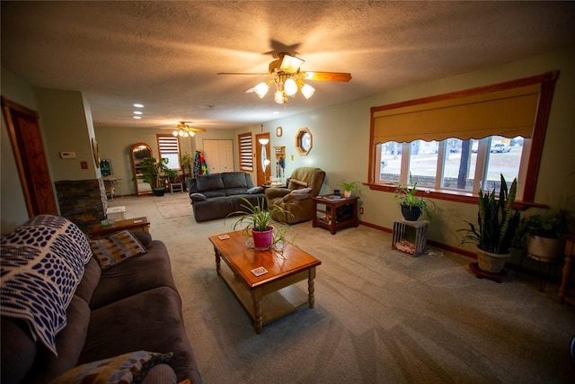 living room with ceiling fan, light colored carpet, and a textured ceiling