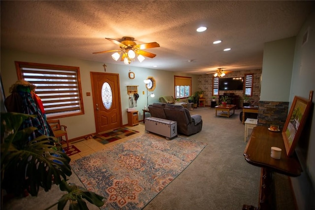 living room with ceiling fan and a textured ceiling