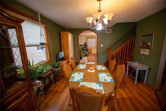 dining room with a chandelier and hardwood / wood-style floors