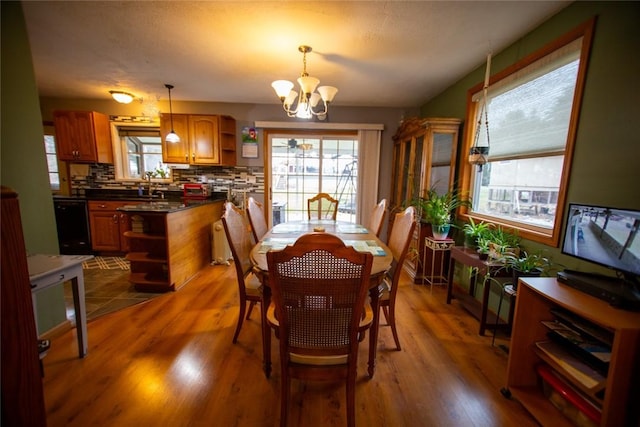 dining space featuring hardwood / wood-style flooring and a chandelier