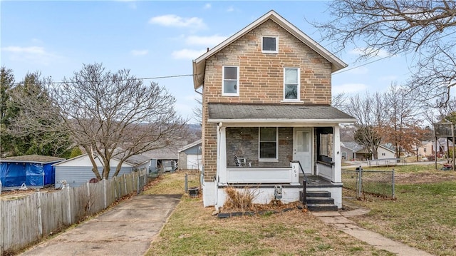 view of property featuring a porch and a front lawn