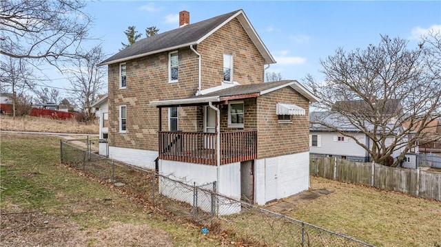 back of property featuring a lawn