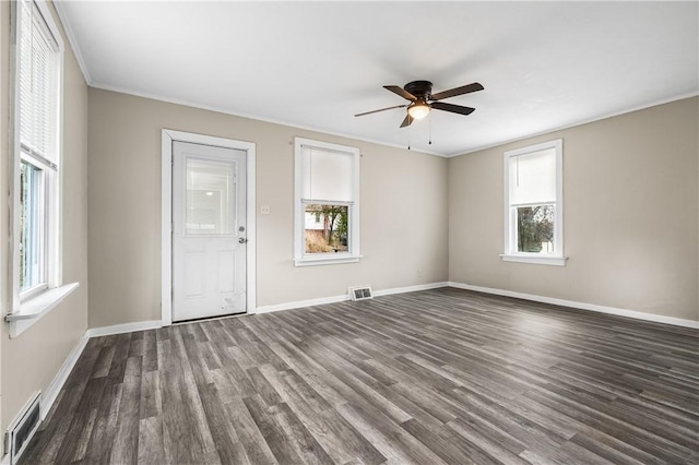 empty room with ceiling fan, ornamental molding, and dark hardwood / wood-style flooring