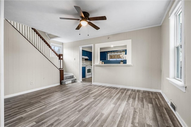 unfurnished living room featuring hardwood / wood-style floors and ceiling fan