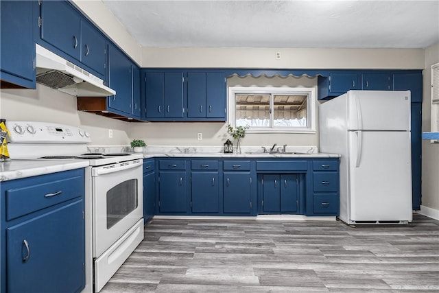 kitchen with white appliances, blue cabinets, light hardwood / wood-style floors, and sink