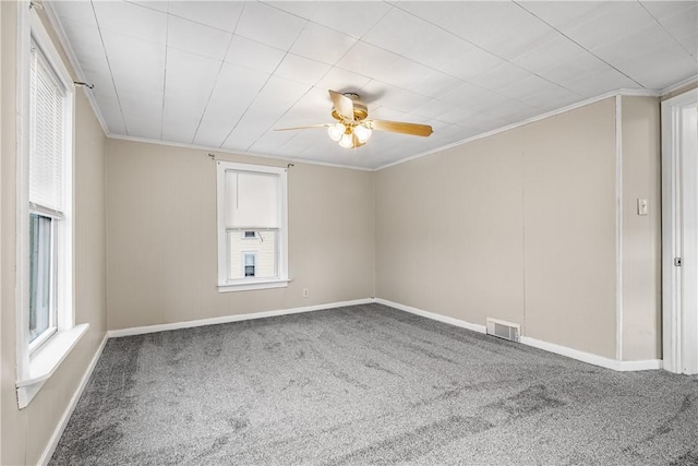 carpeted empty room with crown molding and ceiling fan