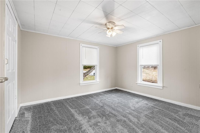 empty room with ornamental molding, plenty of natural light, carpet flooring, and ceiling fan