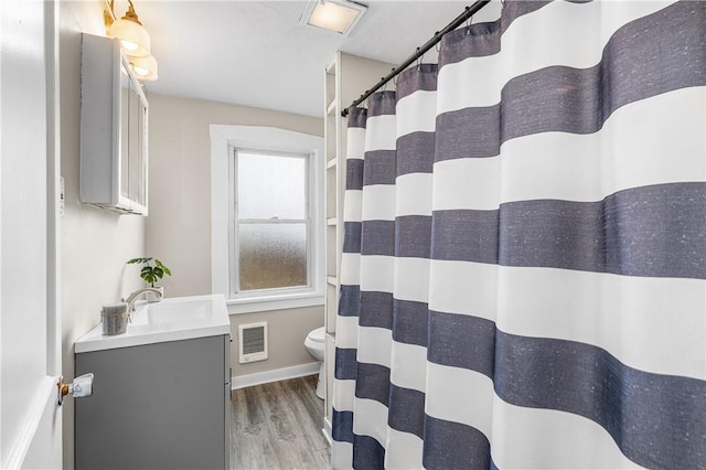 bathroom with vanity, curtained shower, wood-type flooring, and toilet