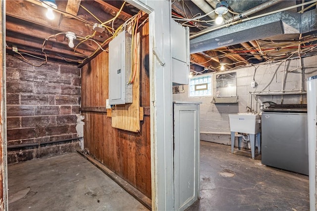 basement featuring washer / clothes dryer, electric panel, and sink