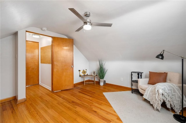 sitting room with vaulted ceiling, ceiling fan, and light hardwood / wood-style flooring