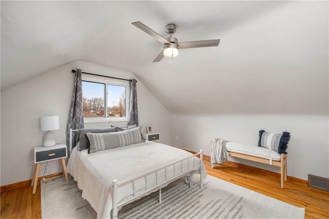 bedroom featuring vaulted ceiling, hardwood / wood-style floors, and ceiling fan