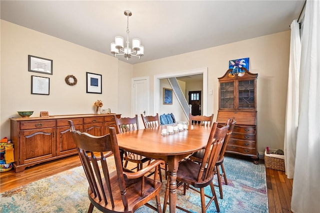 dining room with a notable chandelier and light wood-type flooring