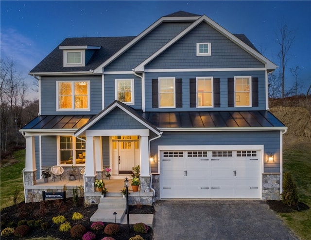 craftsman inspired home featuring a porch and a garage