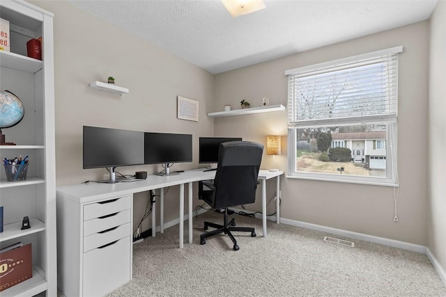 office space with light colored carpet and a textured ceiling