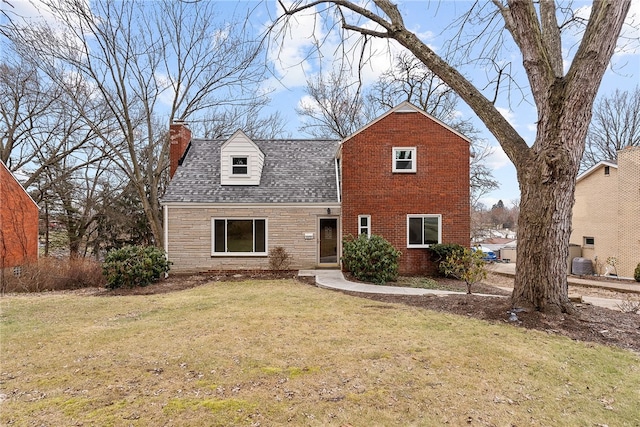 view of front of home with central AC unit and a front yard