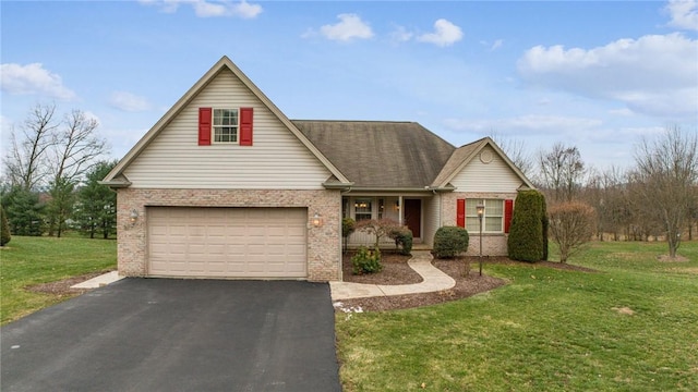 view of front of house with a garage and a front lawn