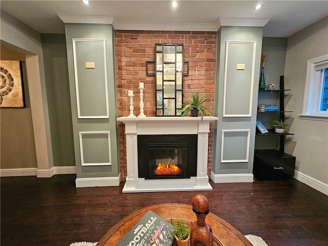 living room featuring a large fireplace, dark hardwood / wood-style floors, and ornamental molding