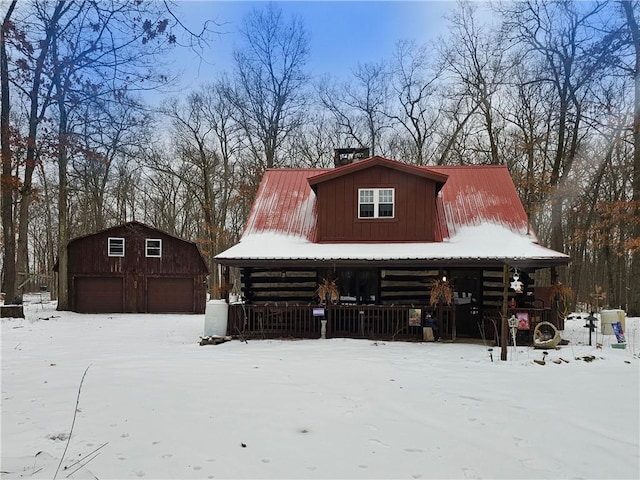 snow covered structure featuring a garage