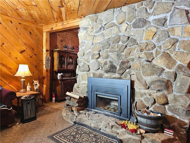 interior details with a fire extinguisher, wood ceiling, wood walls, and a fireplace