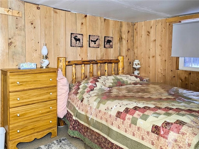 bedroom with wooden walls and carpet floors