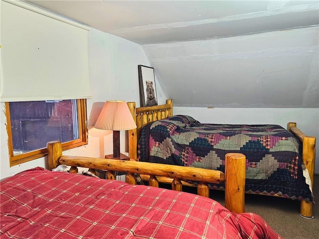 bedroom featuring carpet flooring and vaulted ceiling