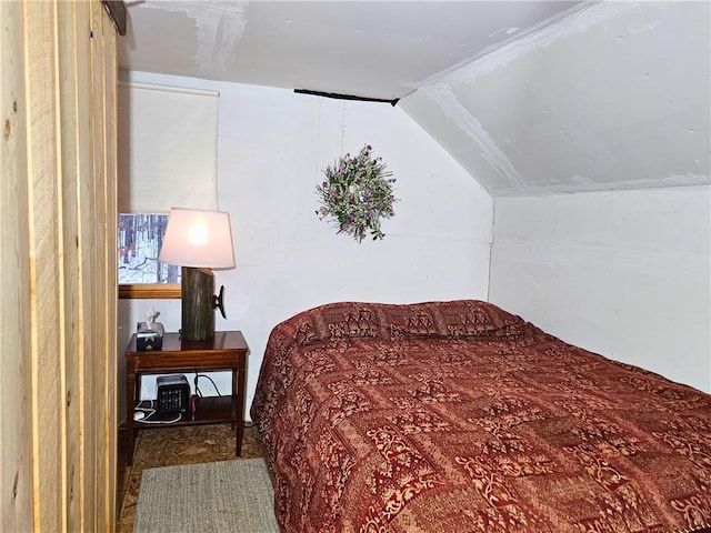 bedroom featuring lofted ceiling