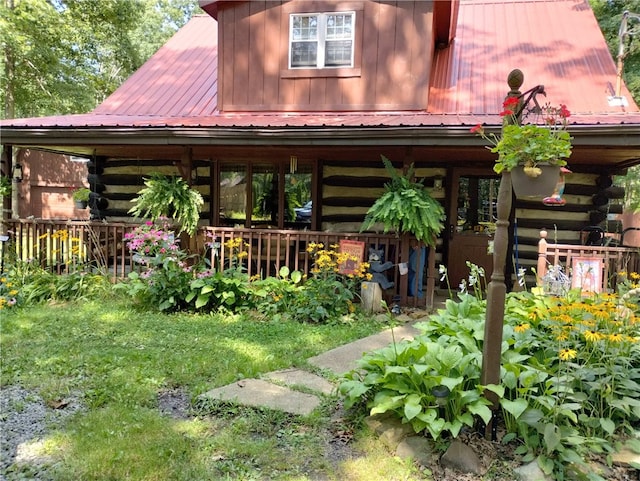 exterior space with metal roof and log exterior