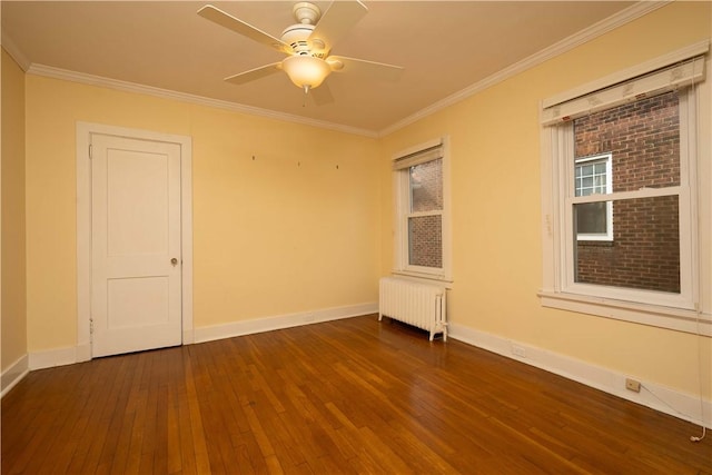 unfurnished room featuring crown molding, dark wood-style flooring, baseboards, and radiator