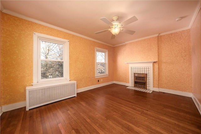 unfurnished living room featuring radiator heating unit, a tiled fireplace, crown molding, and dark wood-style flooring