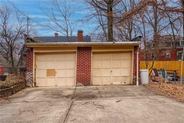 detached garage featuring fence