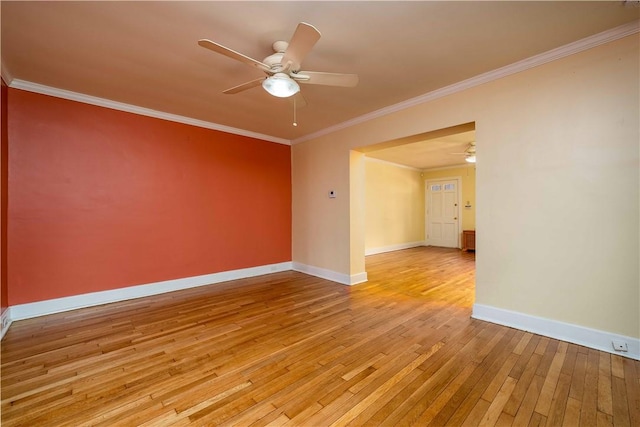 spare room with light wood-style floors, ceiling fan, baseboards, and crown molding