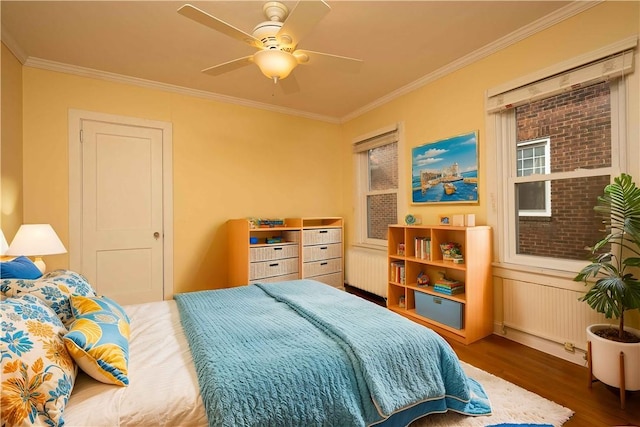 bedroom with dark wood-style floors, ceiling fan, and crown molding