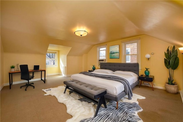 bedroom featuring light carpet, lofted ceiling, and baseboards