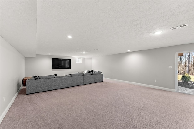 unfurnished living room featuring light colored carpet and a textured ceiling