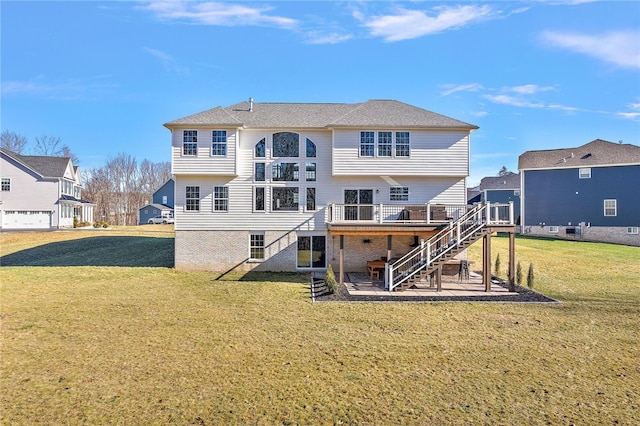 rear view of property with a patio area, a lawn, and a deck