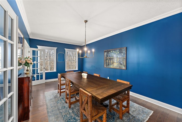 dining room with dark hardwood / wood-style flooring, crown molding, and a chandelier