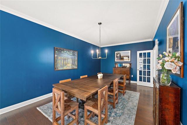 dining area with crown molding, dark hardwood / wood-style flooring, and a notable chandelier