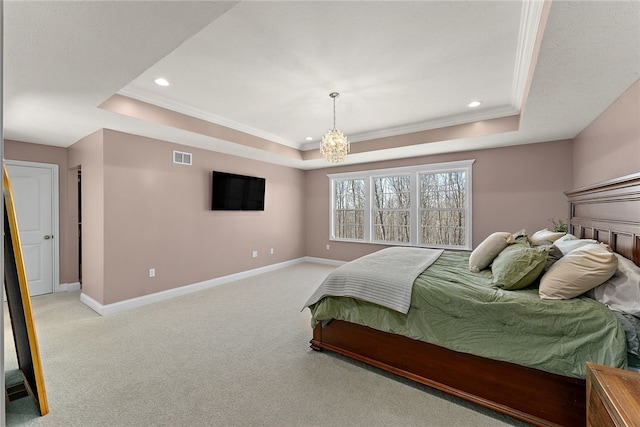 carpeted bedroom with a raised ceiling, ornamental molding, and a notable chandelier