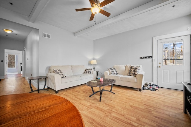 living room with beamed ceiling, ceiling fan, and light hardwood / wood-style flooring