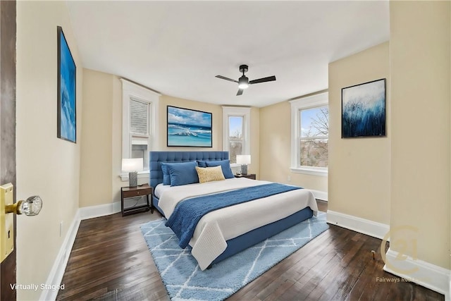 bedroom with dark hardwood / wood-style flooring and ceiling fan