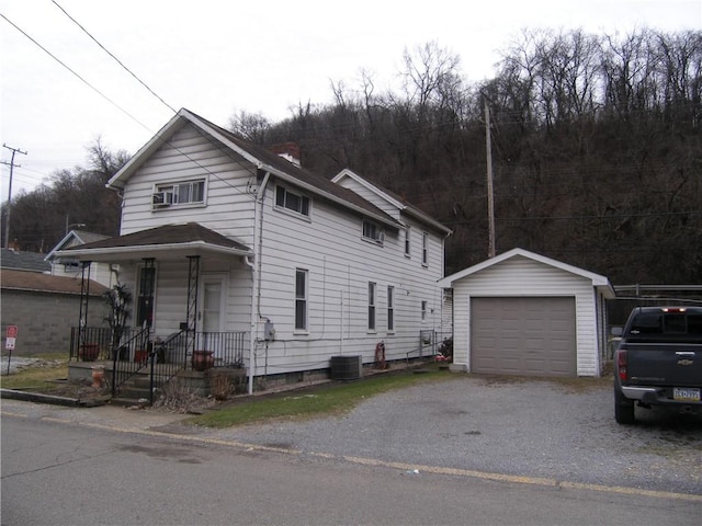 view of front of property with an outbuilding, a garage, and central air condition unit