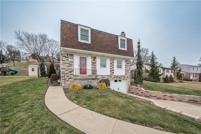 view of front of home with a garage and a front yard