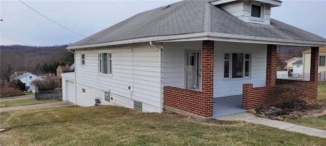 view of home's exterior featuring a garage and a lawn