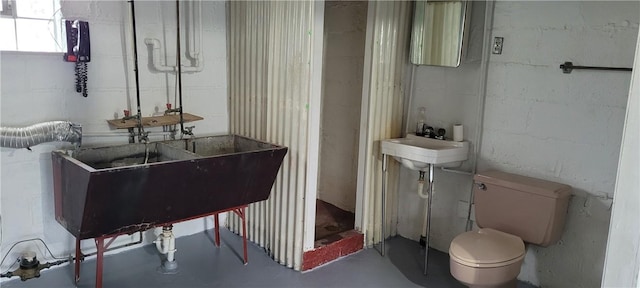 bathroom with sink and concrete floors